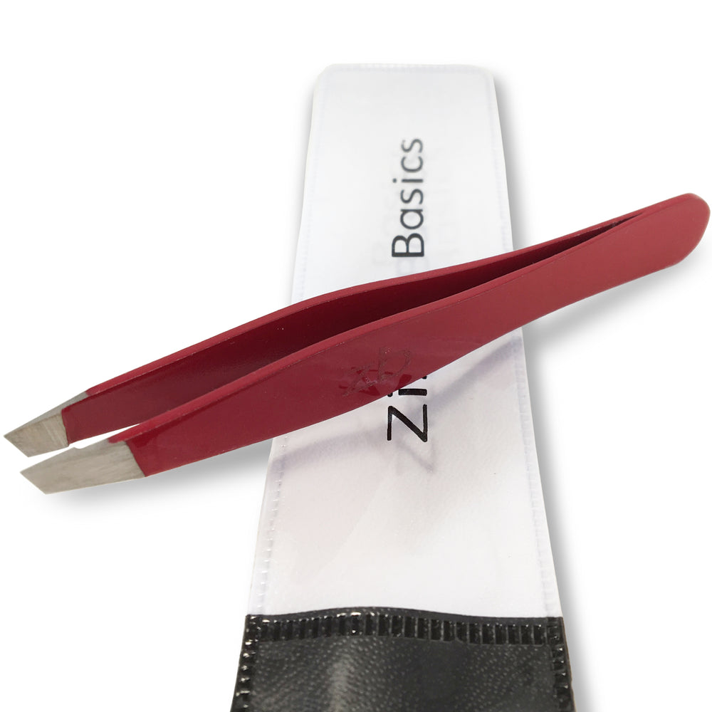 red slanted tweezer on top of carry pouch